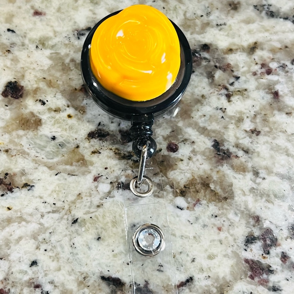 Orange flower diamond badge reel.